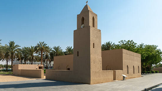 Qasr Al Muwaiji fort and the date palm trees that surround it