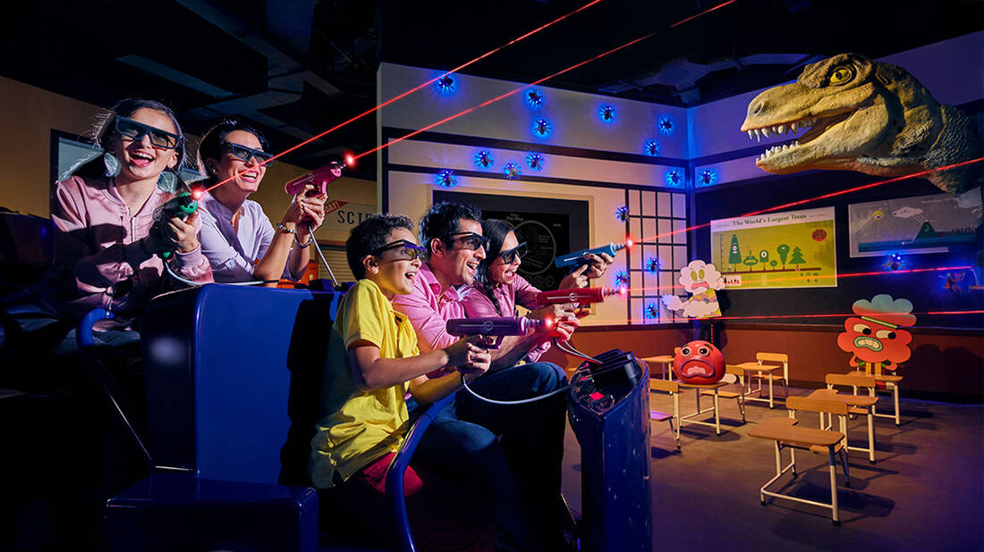 a family enjoying the Gumball ride at IMG World of Adventures