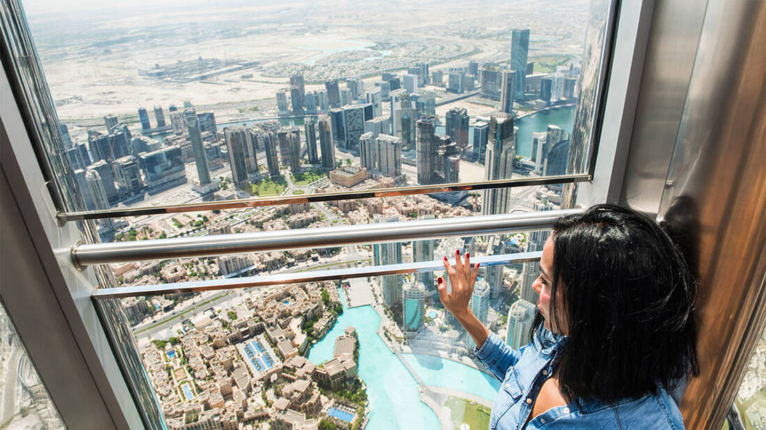 A woman admiring the view from At The Top Burj Khalifa