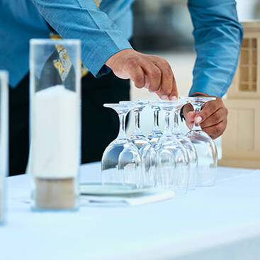 A person organizing glasses