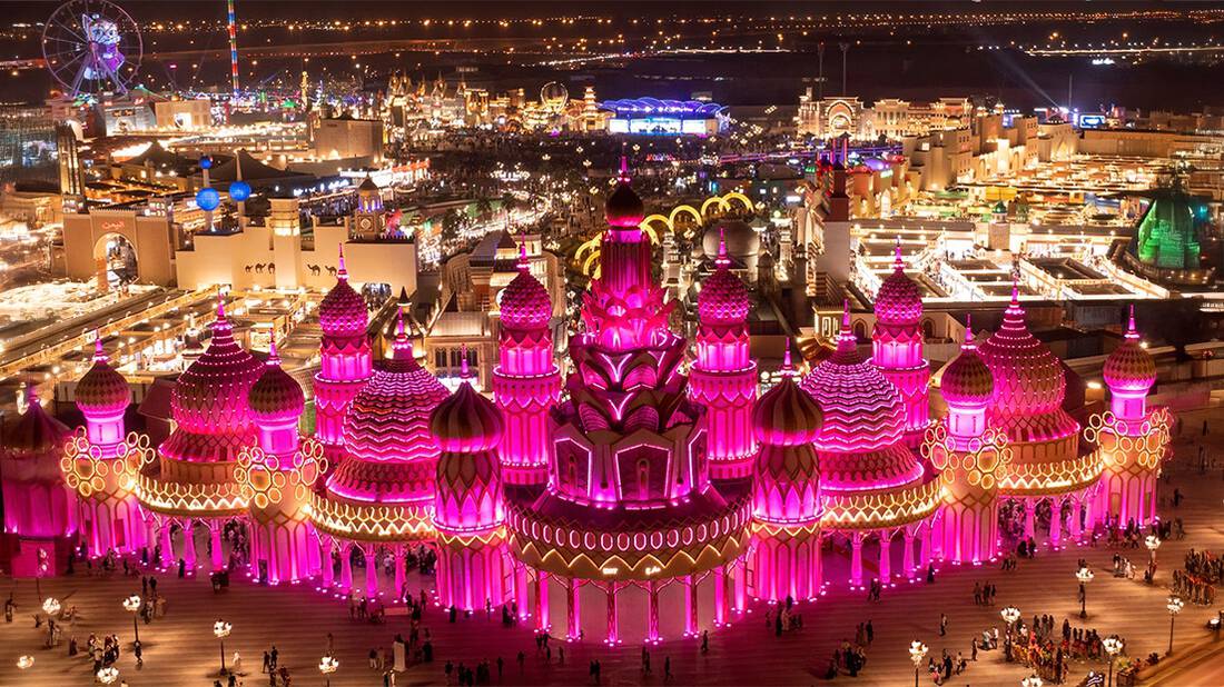Wide view of global village while the main gate is lit up in pink