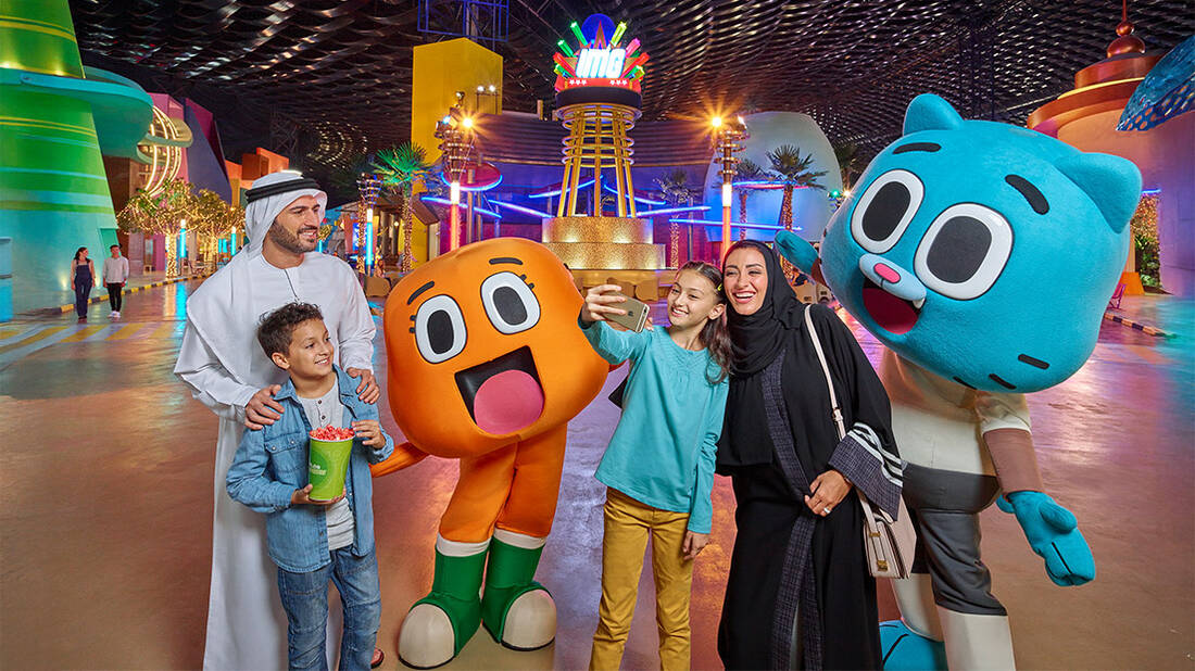 A family taking a picture with Gumball and Darwin at IMG world of adventure