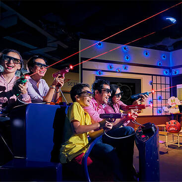 a family on the Gumbball ride at IMG World of Adventures