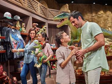 a family at the dinosaur shop at IMG World of Adventures