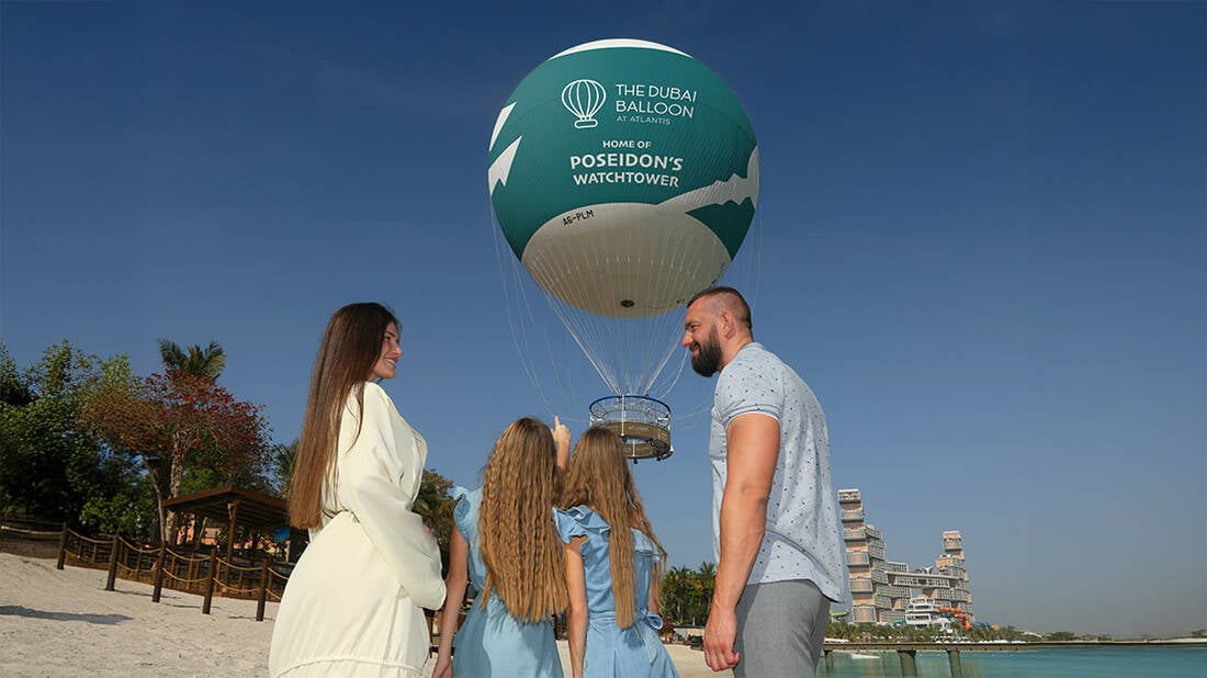 a family taking a picture by The Dubai Balloon at Atlantis