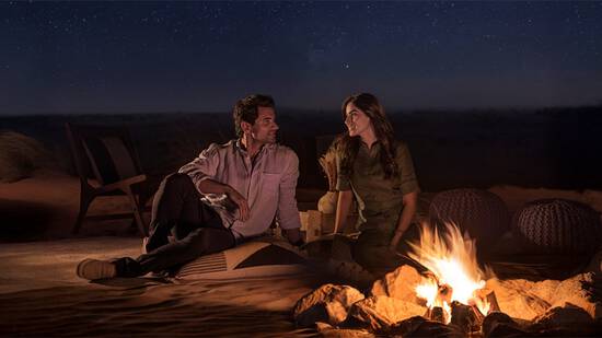A couple enjoying Camp fire