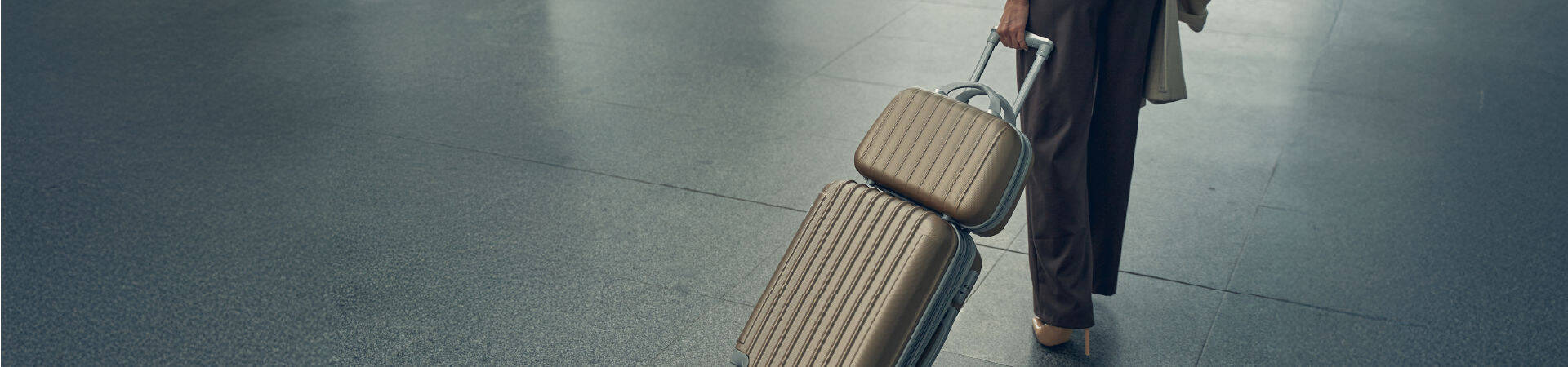 A woman with her bags walking at the airport