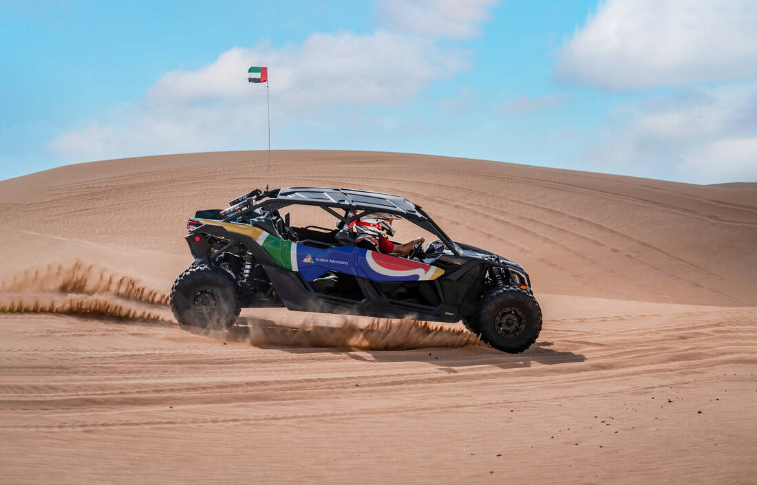 An Arabian Adventures dune buggy being driven in the desert