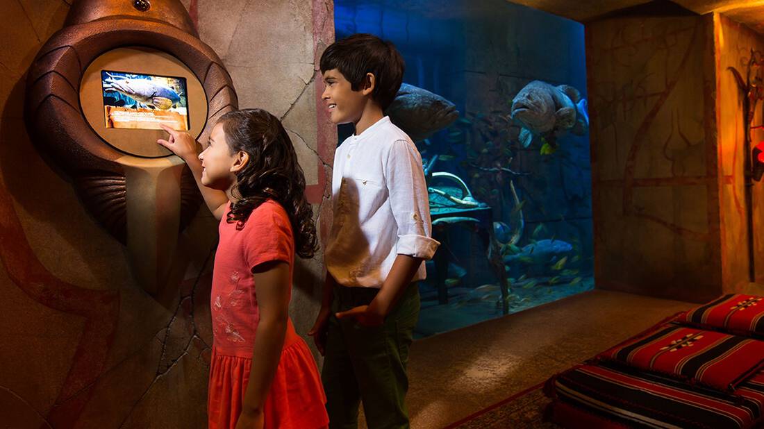 Children looking through a digital screen at The Lost Chambers