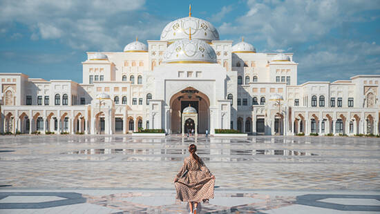 A girl walking towards Qasr Al Watan