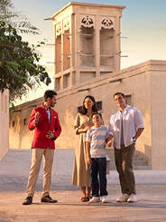 A tour guide with a family of three touring around Al Fahidi Historical District