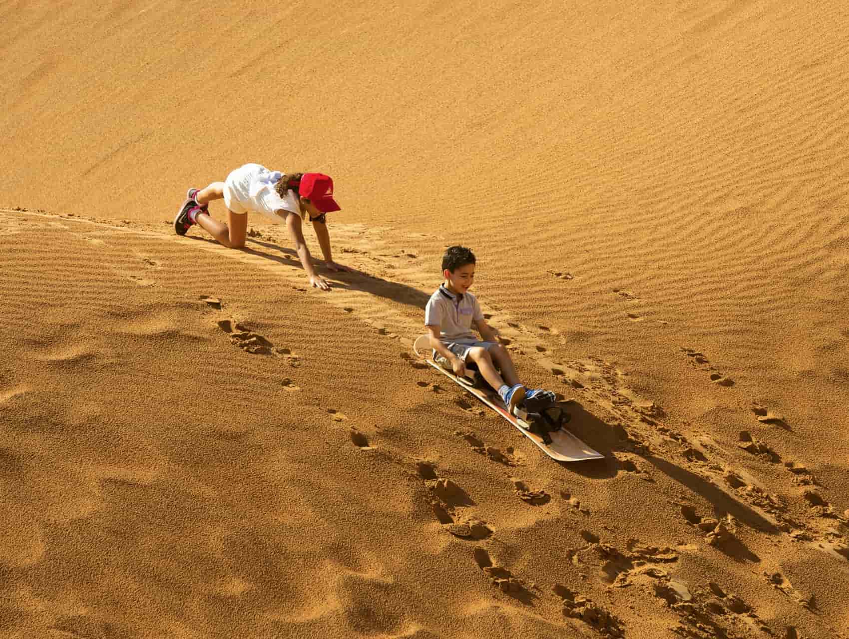 Enjoy sandboarding fun for all on the Morning Desert Adventure