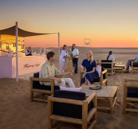People seated at the Whispering Angel bar by the sunset photo stop