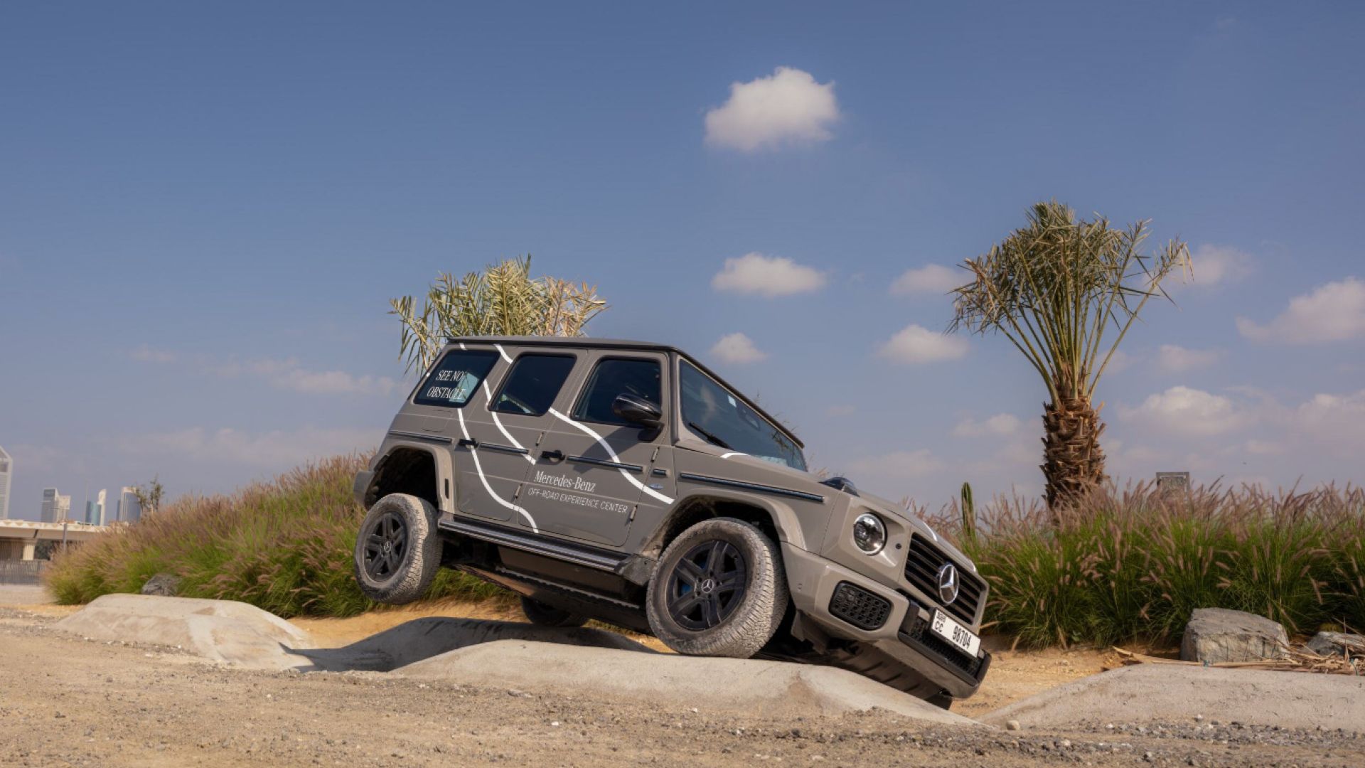 A grey Mercedes Benz G Class off roading